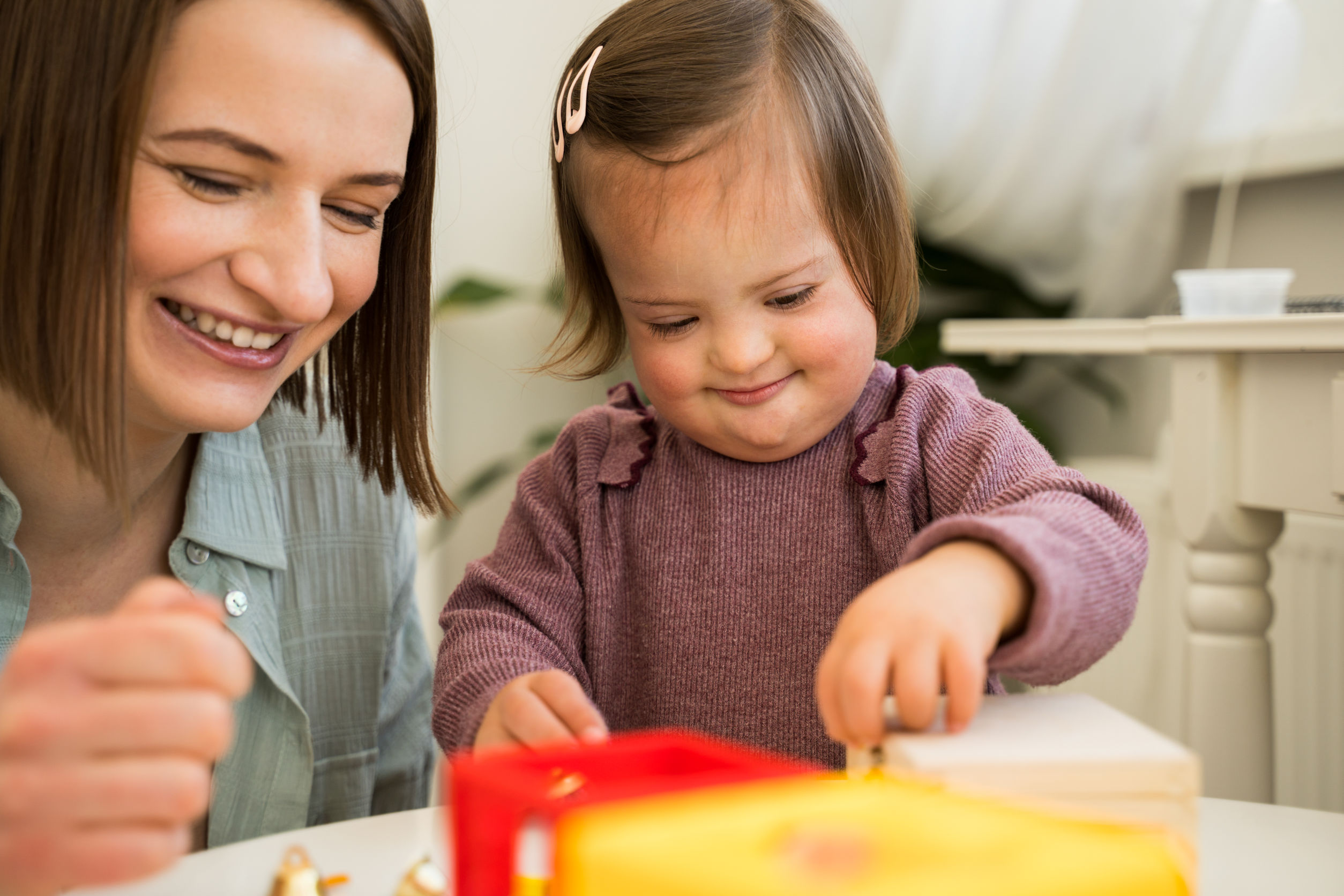caregiver teaching toddler