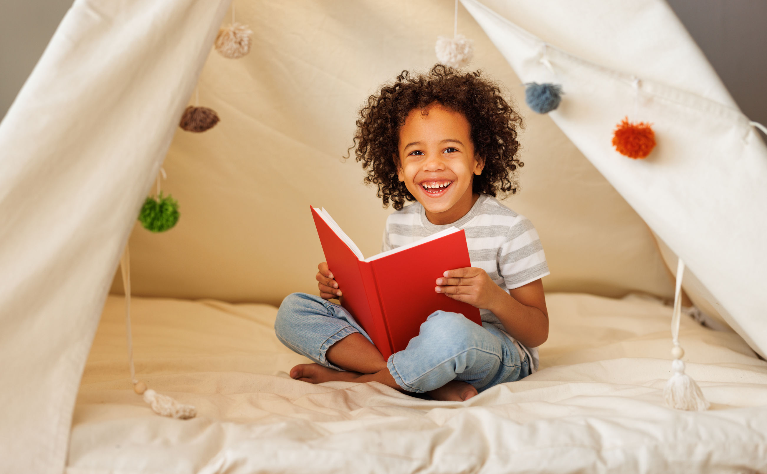 Boy calm with book in cozy corner