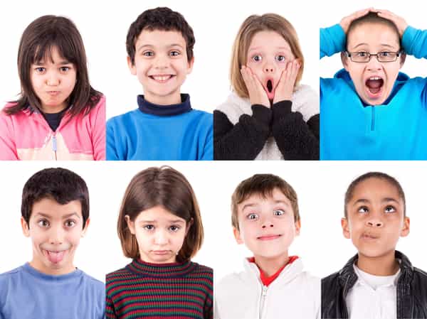 A diverse group of children or adults expressing different emotions, showcasing the universality of emotions across different ages and cultures.
